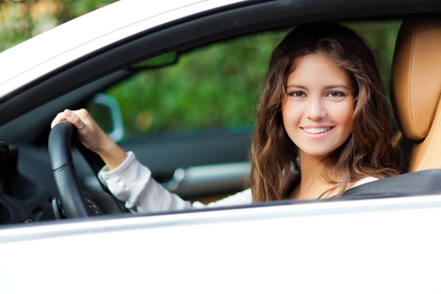 Woman Driving a White Car